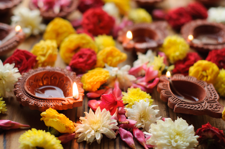 Colorful clay diya lamps lit during diwali celebration.