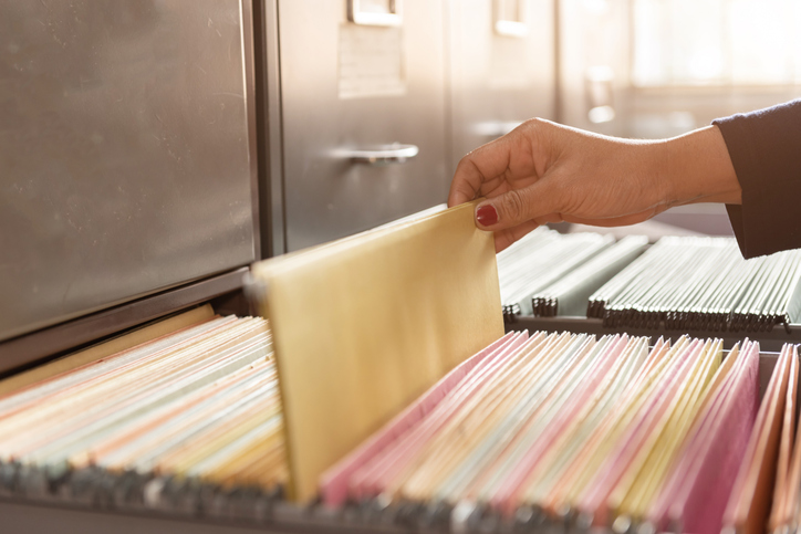 Looking through a filing cabinet.