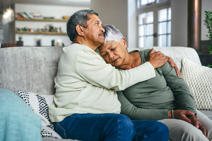 Shot of a senior man supporting his wife during a difficult time at home.